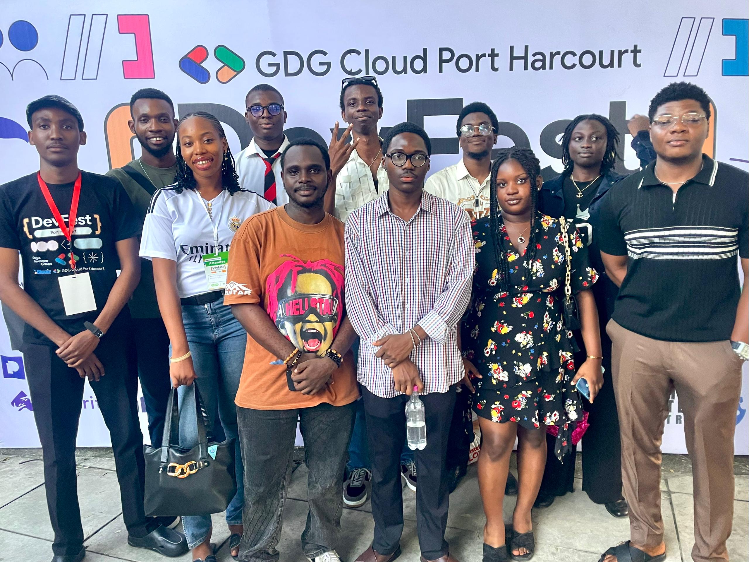 Group photo with fellow attendees in front of the DevFest Port Harcourt backdrop.